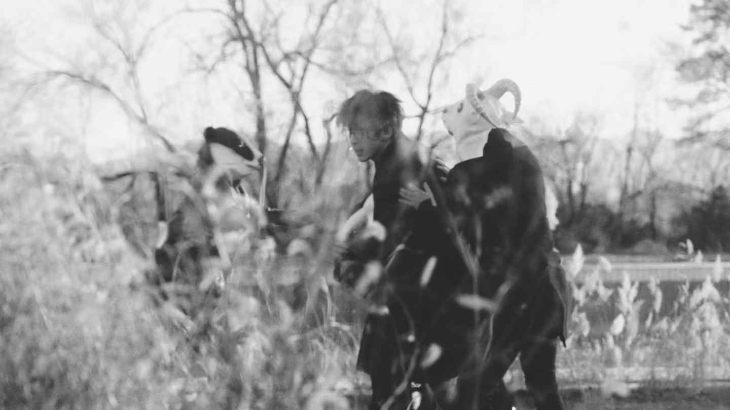 Figures moving through tall reeds
