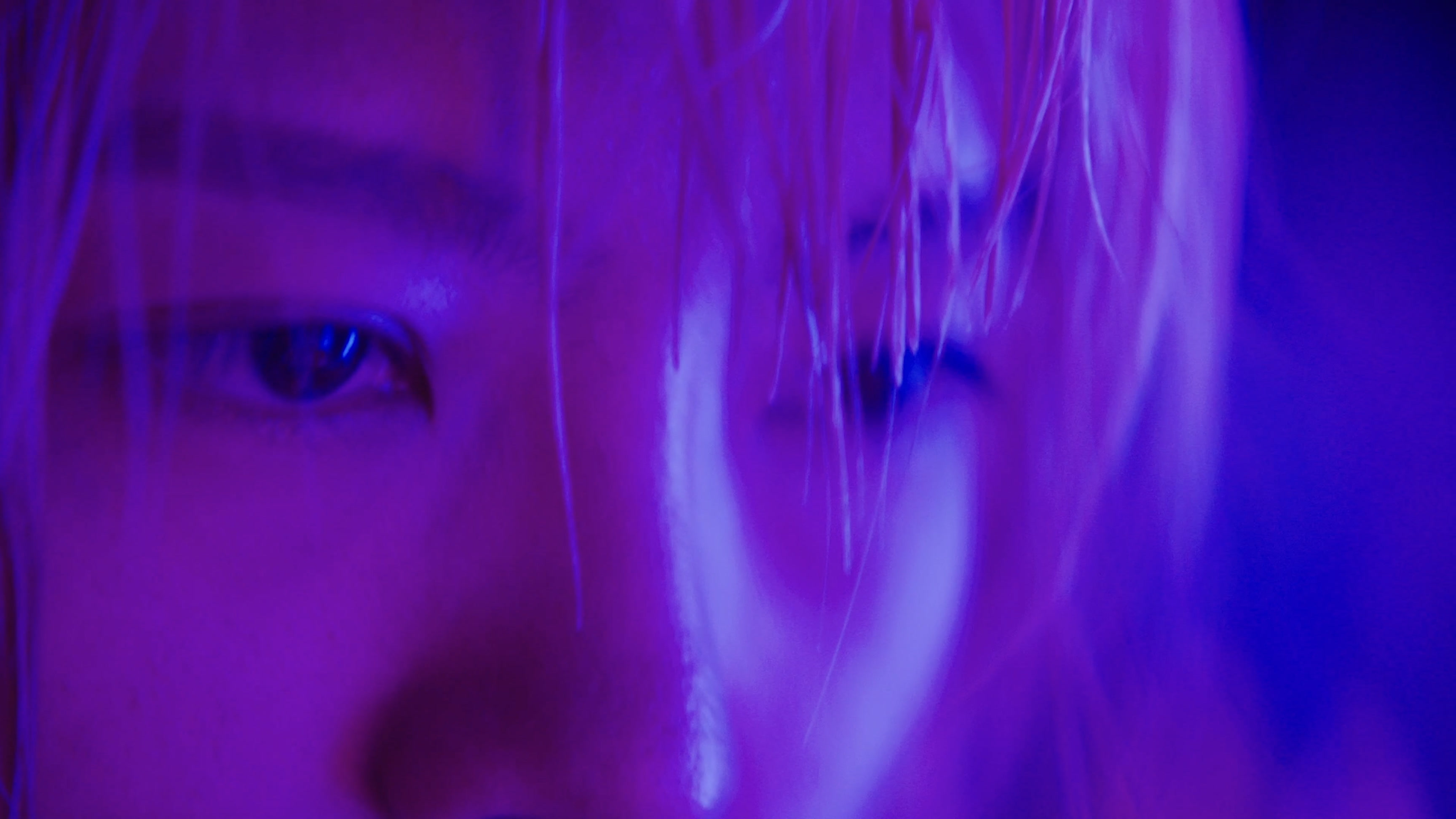 BLONDE — eyes in purple and blue light