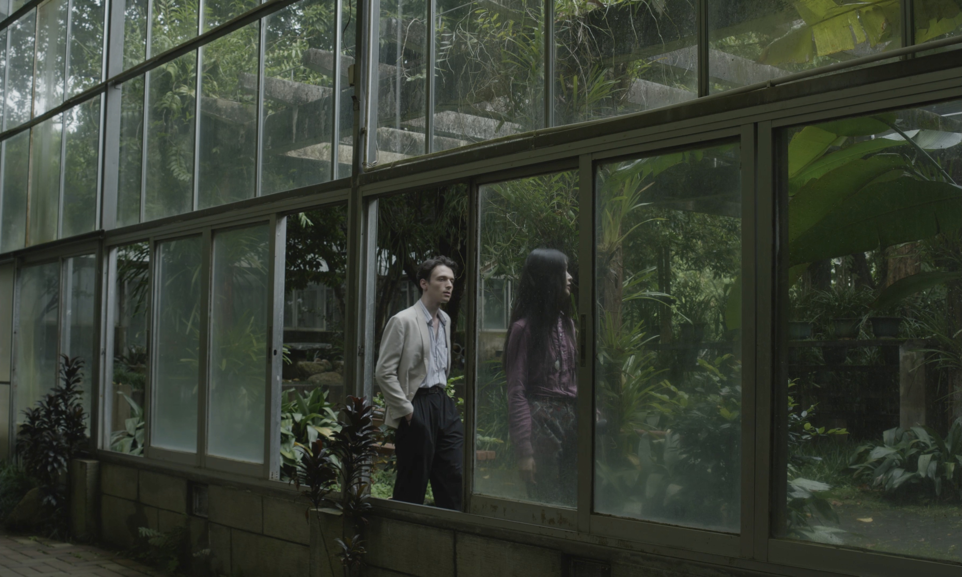 Figures beside a glass greenhouse