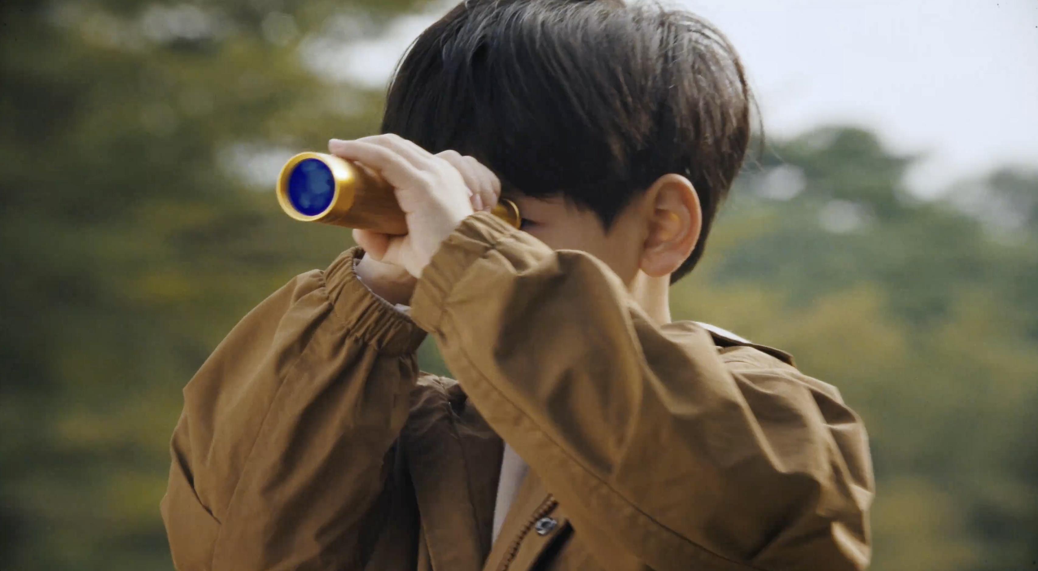 A child looking through a telescope