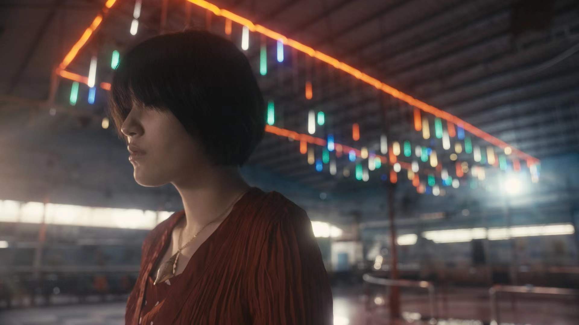 A woman beneath coloured lights at a skating rink