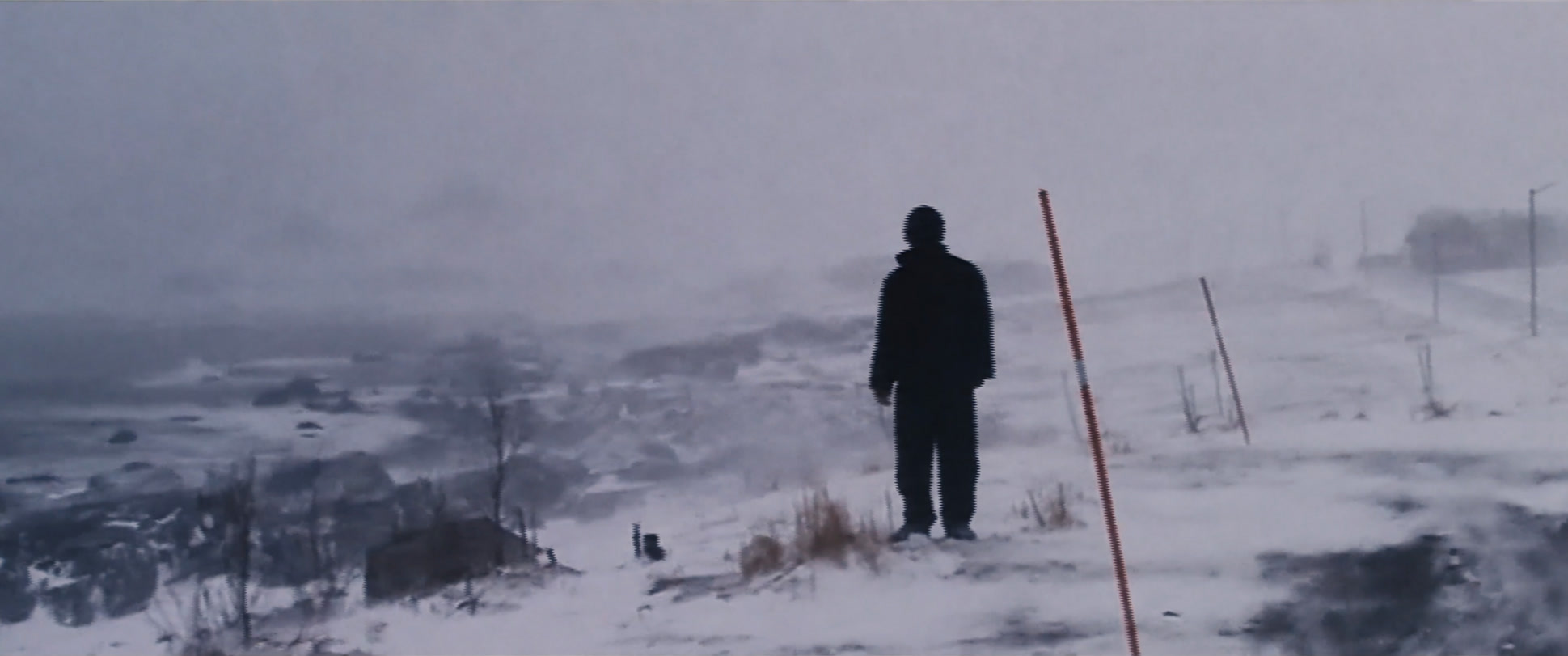 A figure standing in a snowy landscape