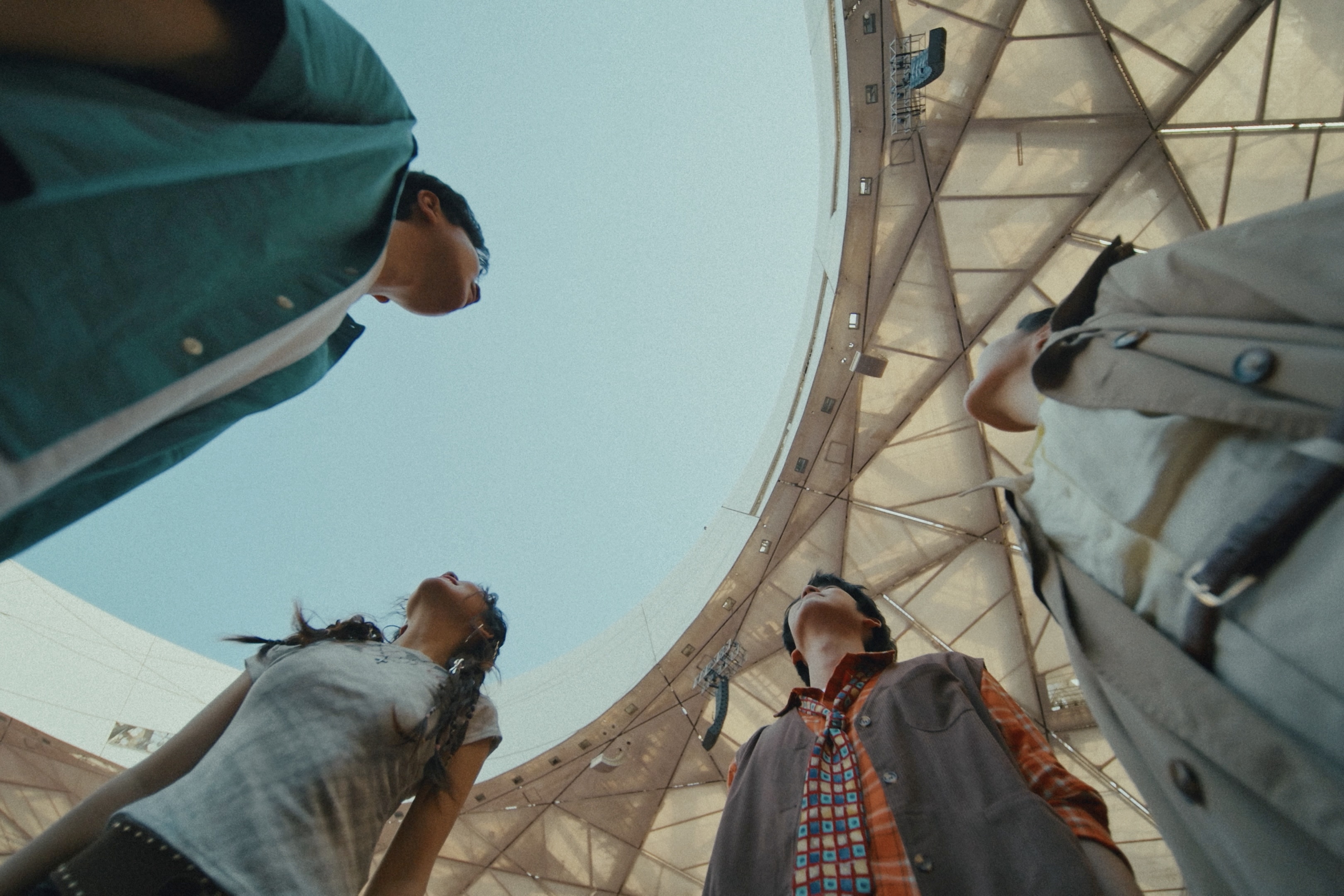 Four people looking upward inside the stadium