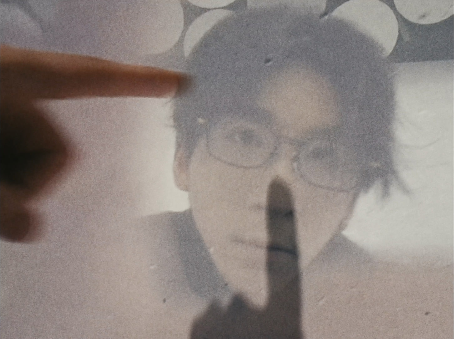 A face seen through translucent material