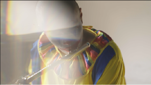 A clown playing a flute in soft sunlight