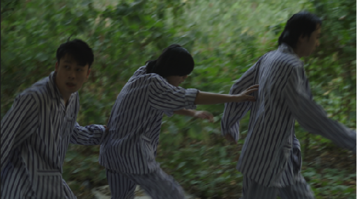 Figures in striped clothing moving through a forest