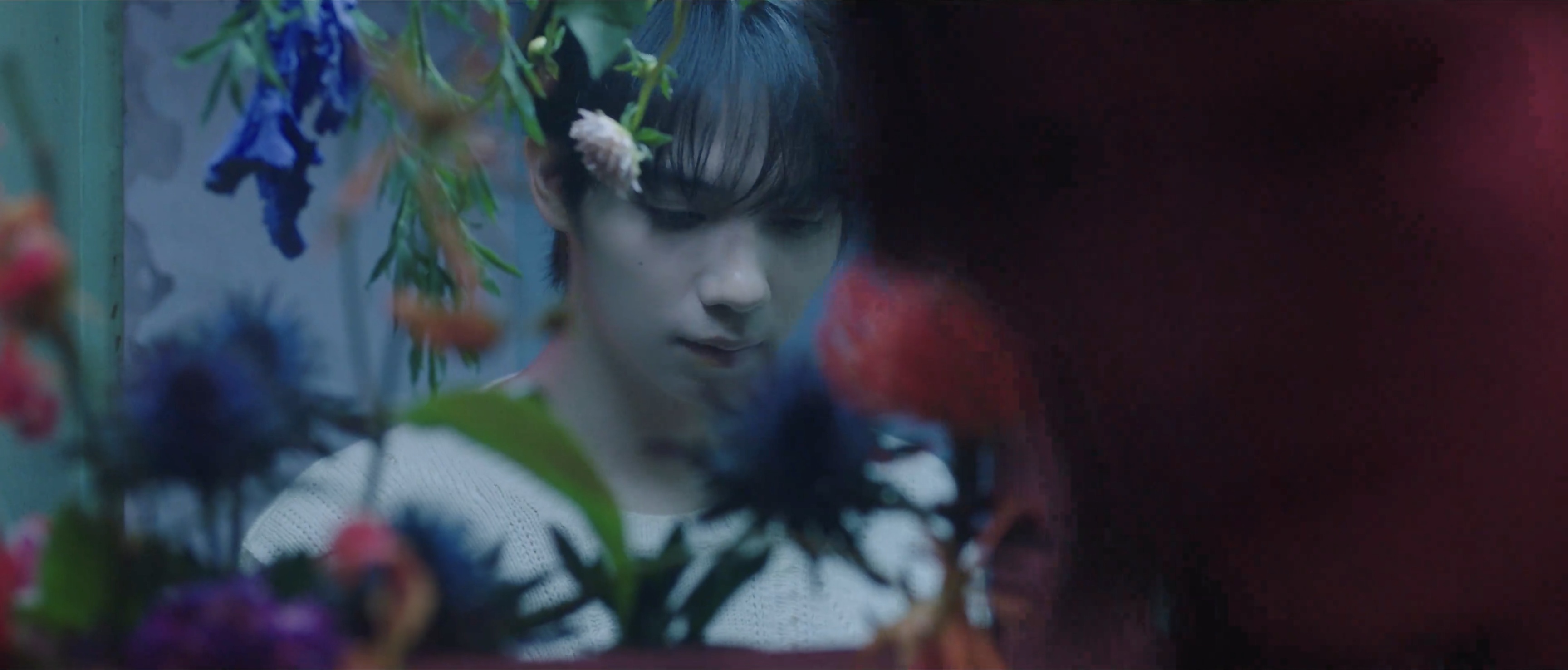 A portrait framed by hanging flowers