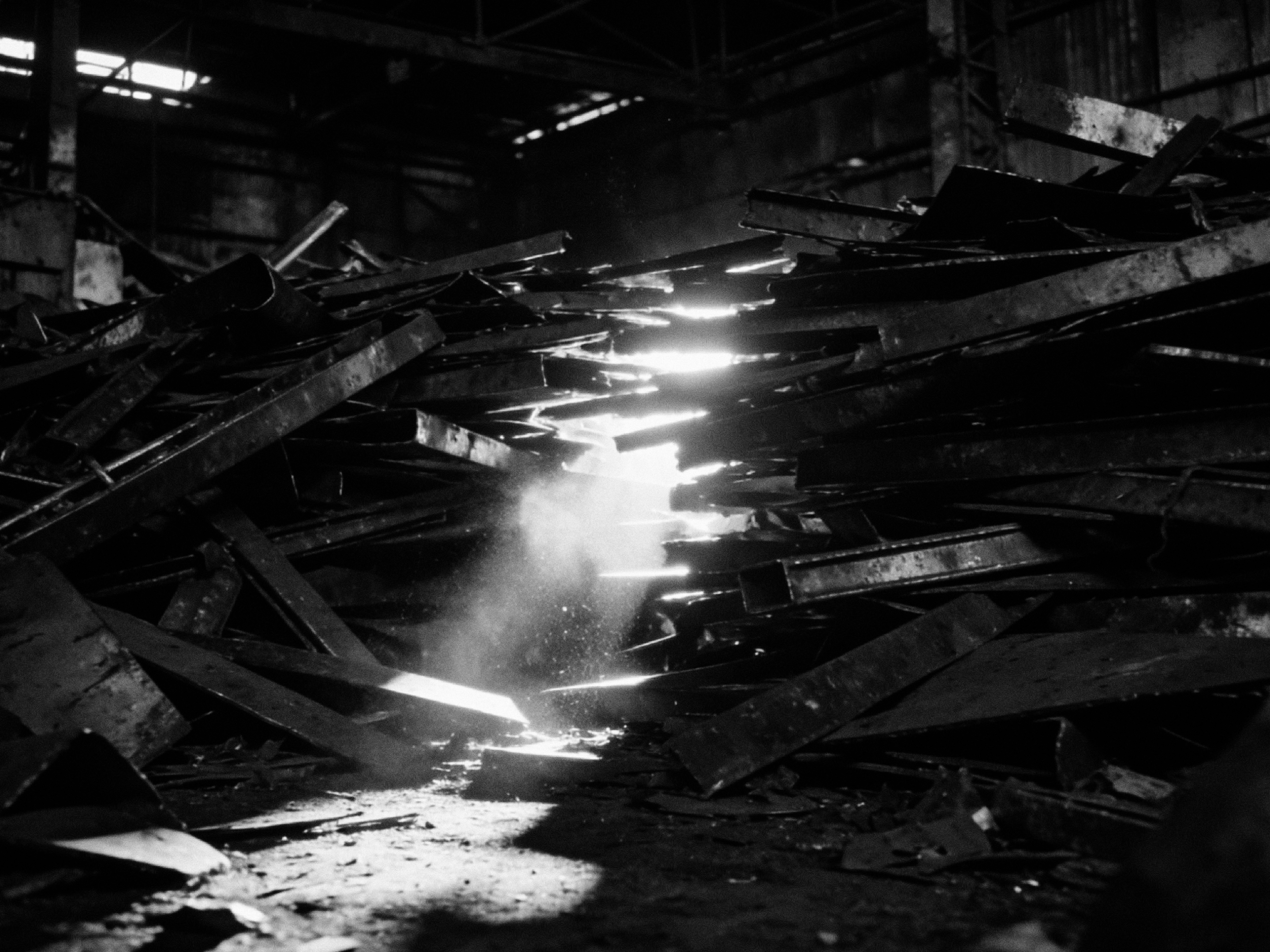 Light falling through a warehouse of scrap metal